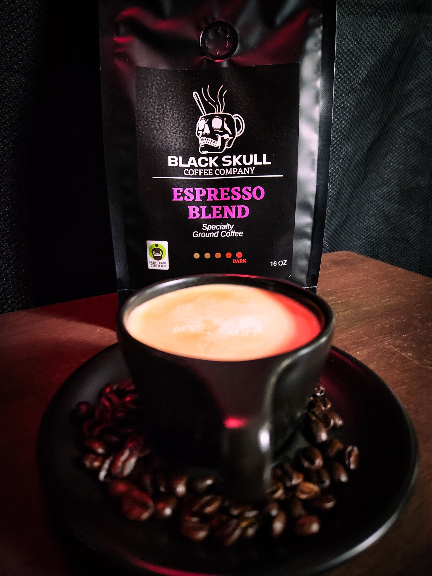 Black Skull Coffee Company Espresso Blend package with a cup of coffee and coffee beans on a dark surface